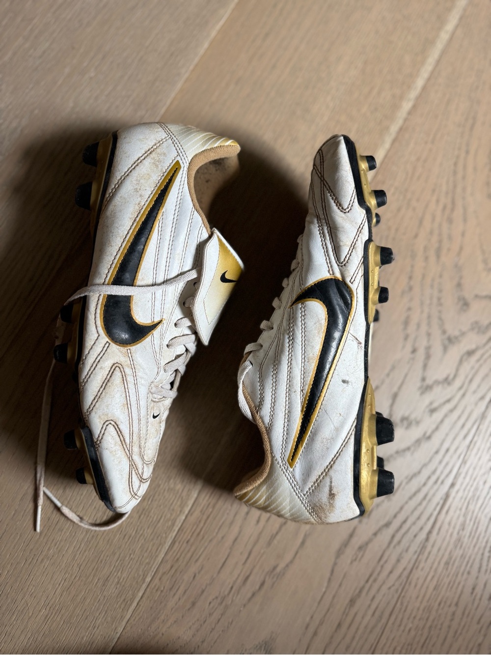 Nike Men’s White Soccer Shoes with Black Swoosh and Gold Highlights